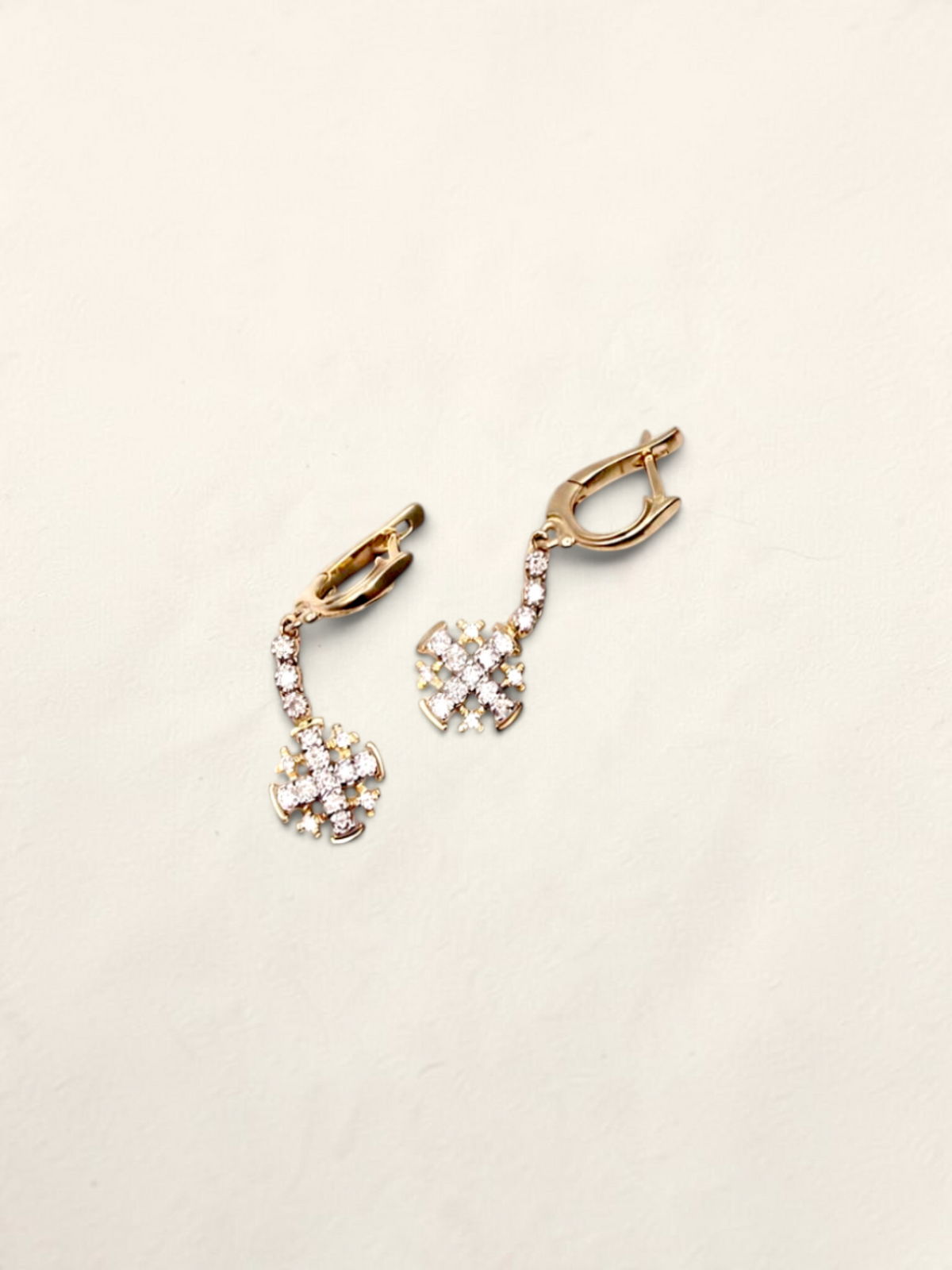 Zafrah 14K yellow gold drop earrings featuring diamond-encrusted cross charms with secure latch back closures.