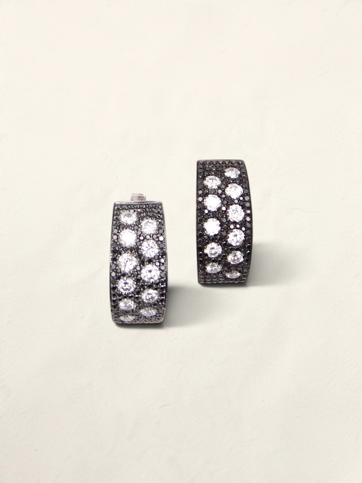 Zafrah 14K white gold huggie hoop earrings featuring a pave setting of round black and white diamonds.