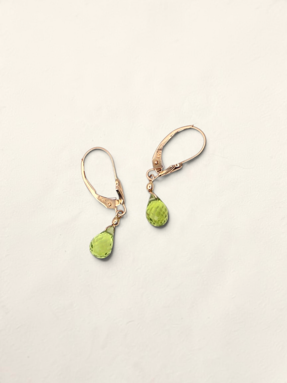 Zafrah 14k yellow gold huggie hoop earrings featuring faceted pear-shaped green quartz drops