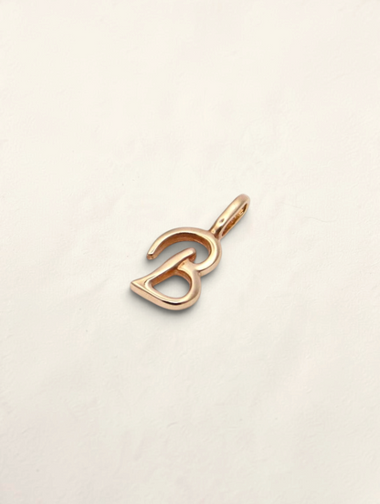 Zafrah 14K yellow gold initial B pendant with a polished finish on a neutral background