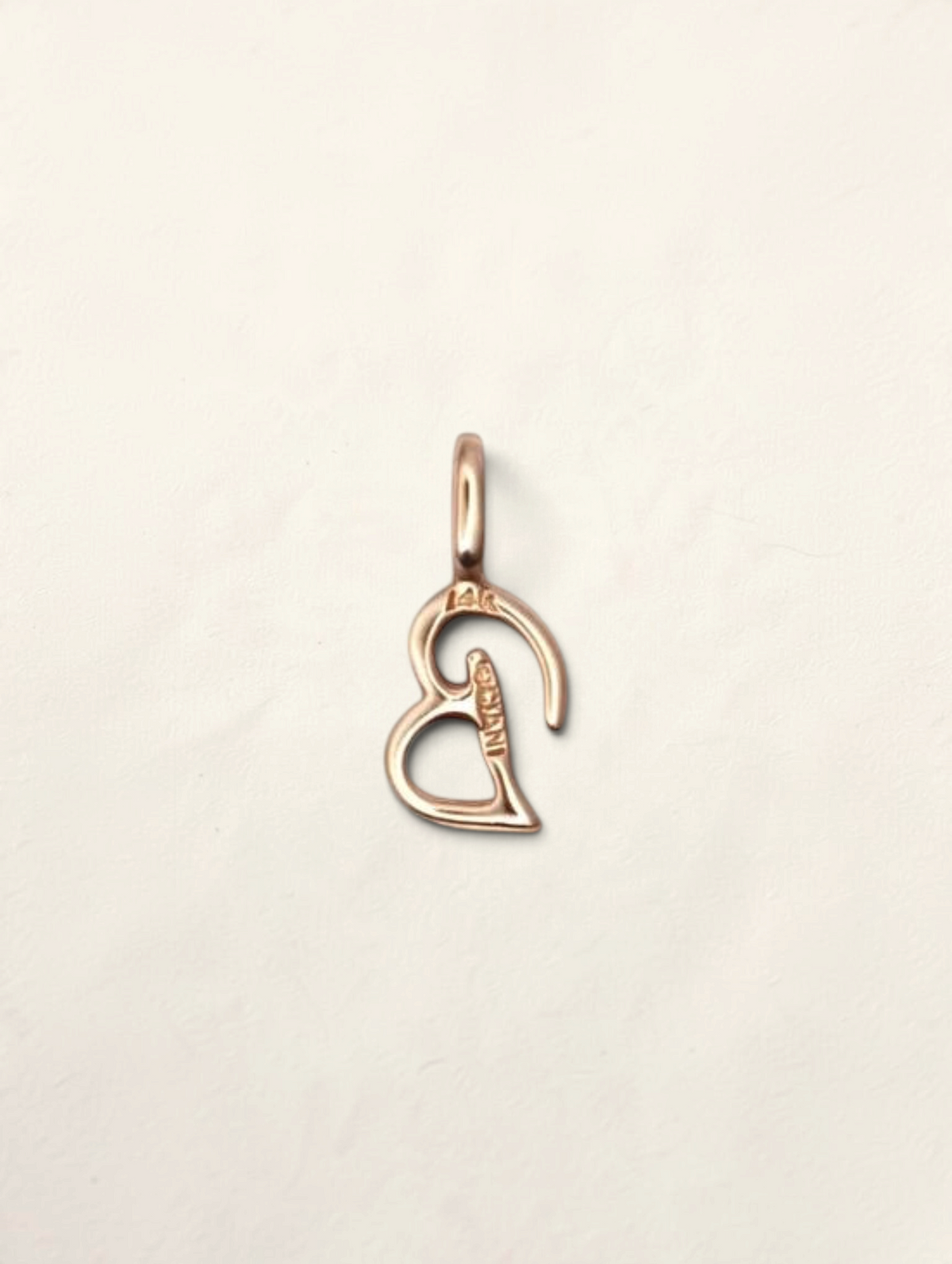 Zafrah 14K yellow gold initial B pendant with a polished finish on a neutral background