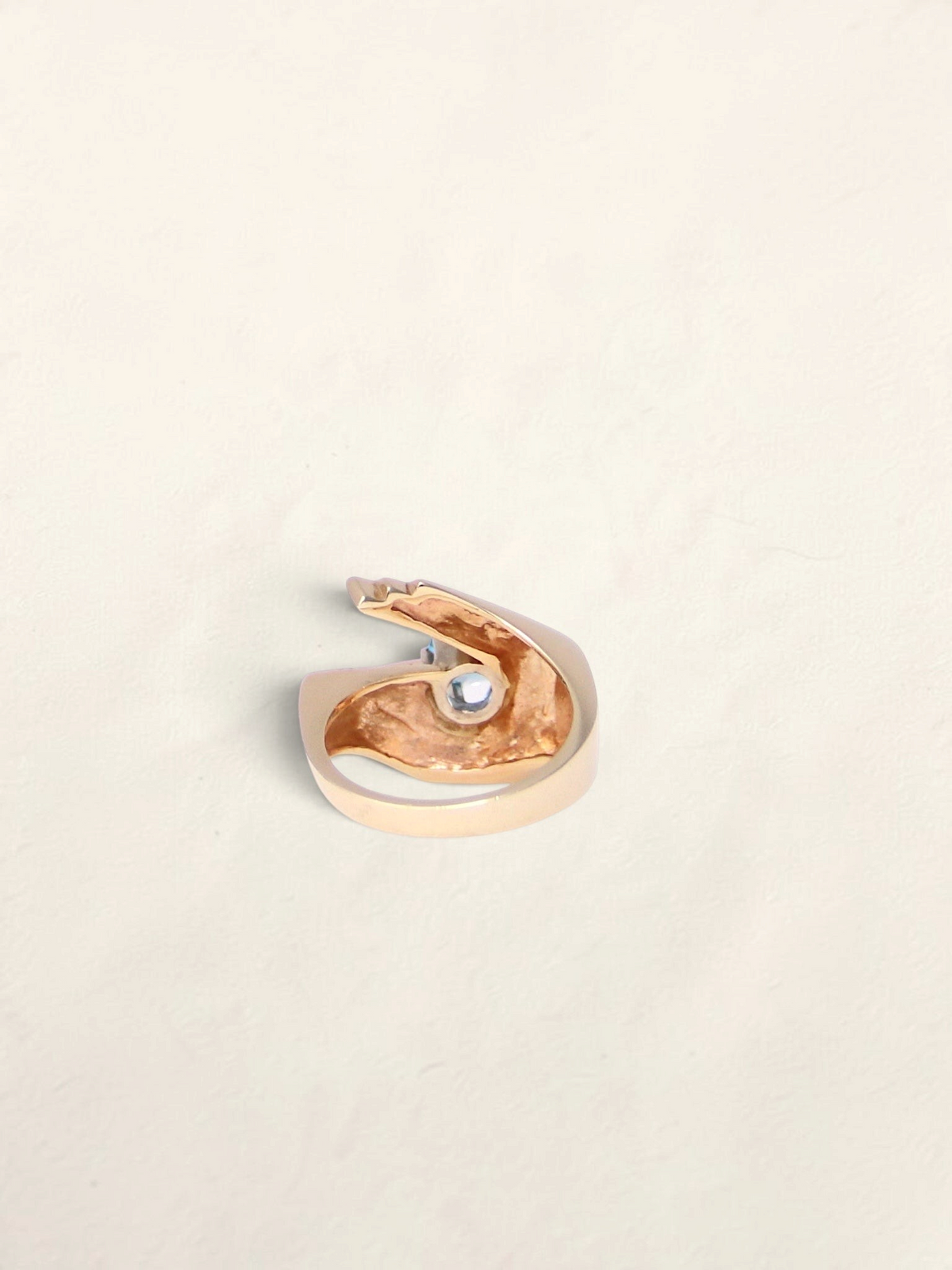 Zafrah 14K yellow gold abstract ring featuring a 1ct round blue topaz stone in a unique sculptural design.