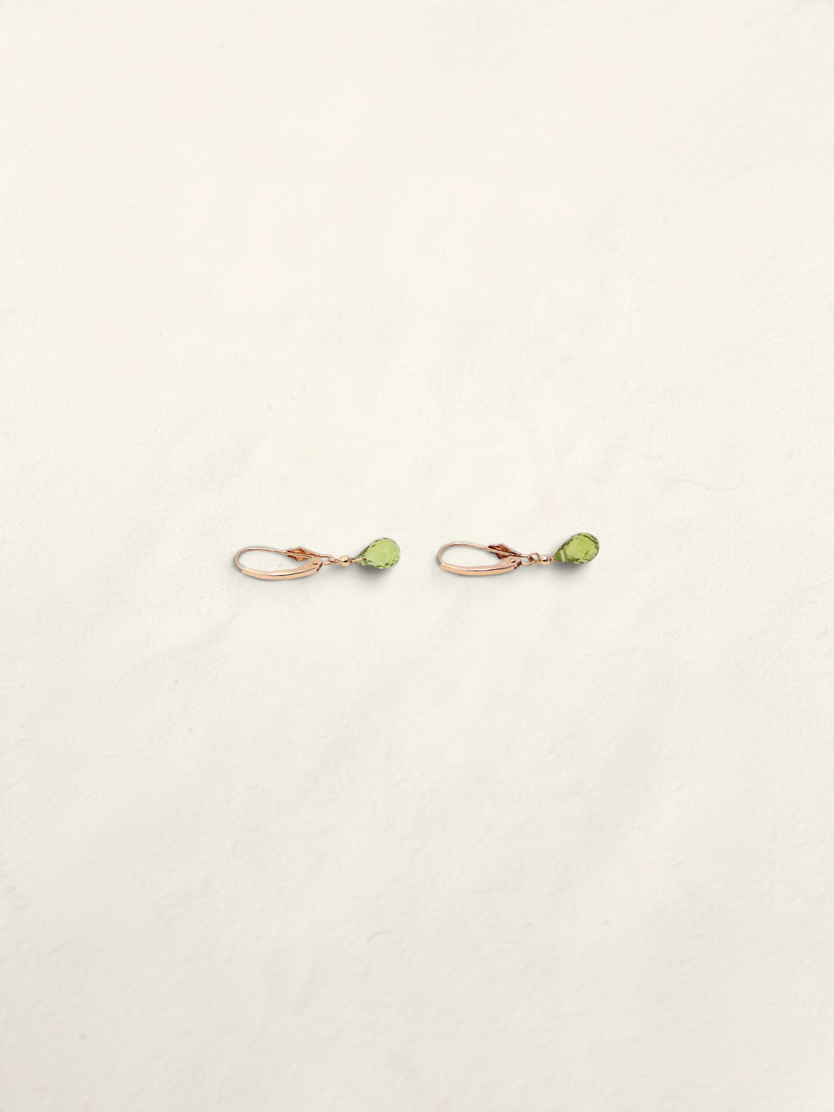 Zafrah 14k yellow gold huggie hoop earrings featuring delicate teardrop-shaped green quartz gemstones