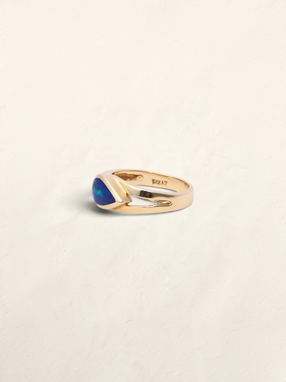 Zafrah 14K yellow gold ring featuring a vibrant blue boulder opal inlay in a sleek, polished band design.