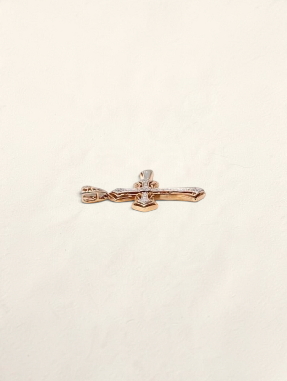 Zafrah 10k yellow gold cross pendant featuring 44 round diamonds totaling 0.22ctw, shown from a side angle.