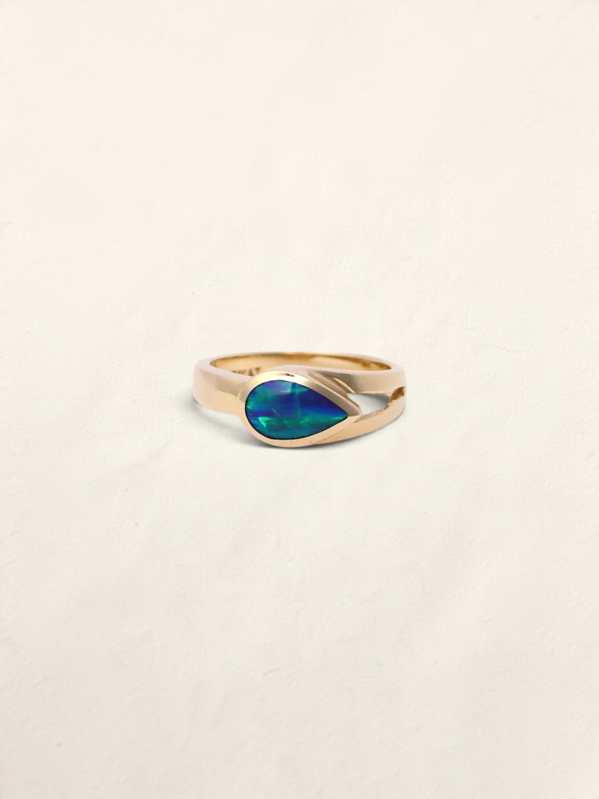 Zafrah 14k yellow gold ring featuring a teardrop-shaped boulder opal inlay on a smooth polished band