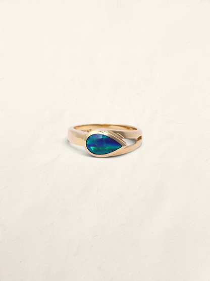 Zafrah 14k yellow gold ring featuring a teardrop-shaped boulder opal inlay on a smooth polished band