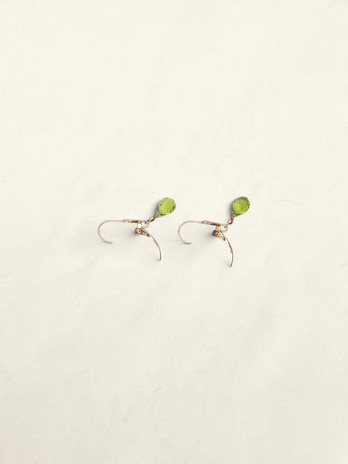 Zafrah 14K yellow gold huggie hoop earrings featuring delicate teardrop-shaped green quartz gemstones