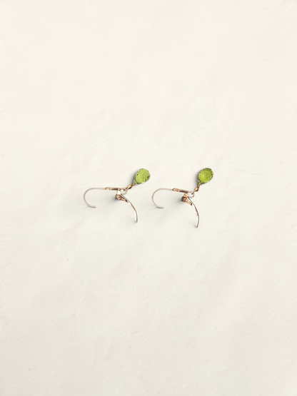 Zafrah 14K yellow gold huggie hoop earrings featuring delicate teardrop-shaped green quartz gemstones