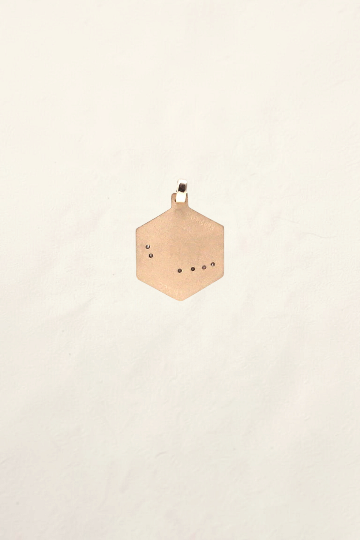 Zafrah 14K yellow gold hexagonal Capricorn pendant featuring six small round diamonds in a constellation pattern.