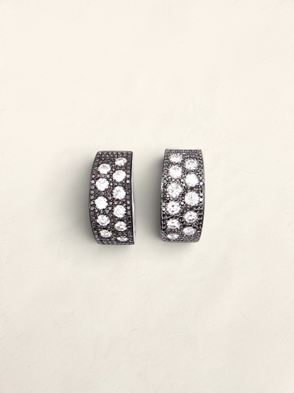 Zafrah 14K white gold huggie hoop earrings featuring a pavé design with round black and white diamonds.
