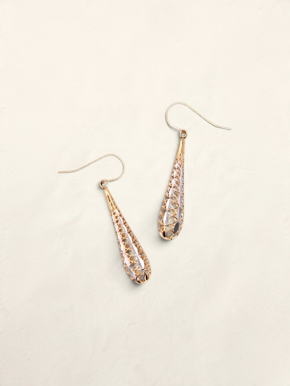 Zafrah 14K two-tone gold lattice dropdown earrings with a delicate teardrop design on a light background.