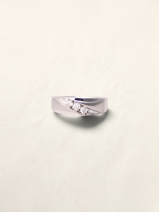 Zafrah 10k white gold band featuring three round brilliant cut diamonds set in a diagonal channel