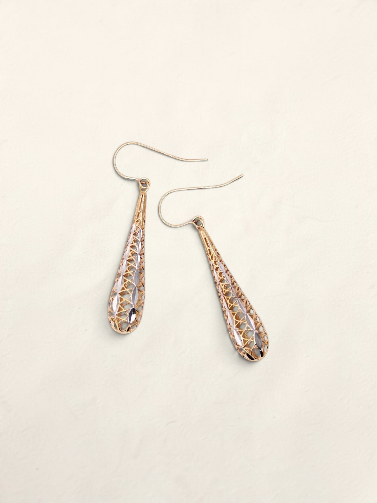 Zafrah 14K two-tone gold dropdown earrings featuring an intricate lattice design on a light background.