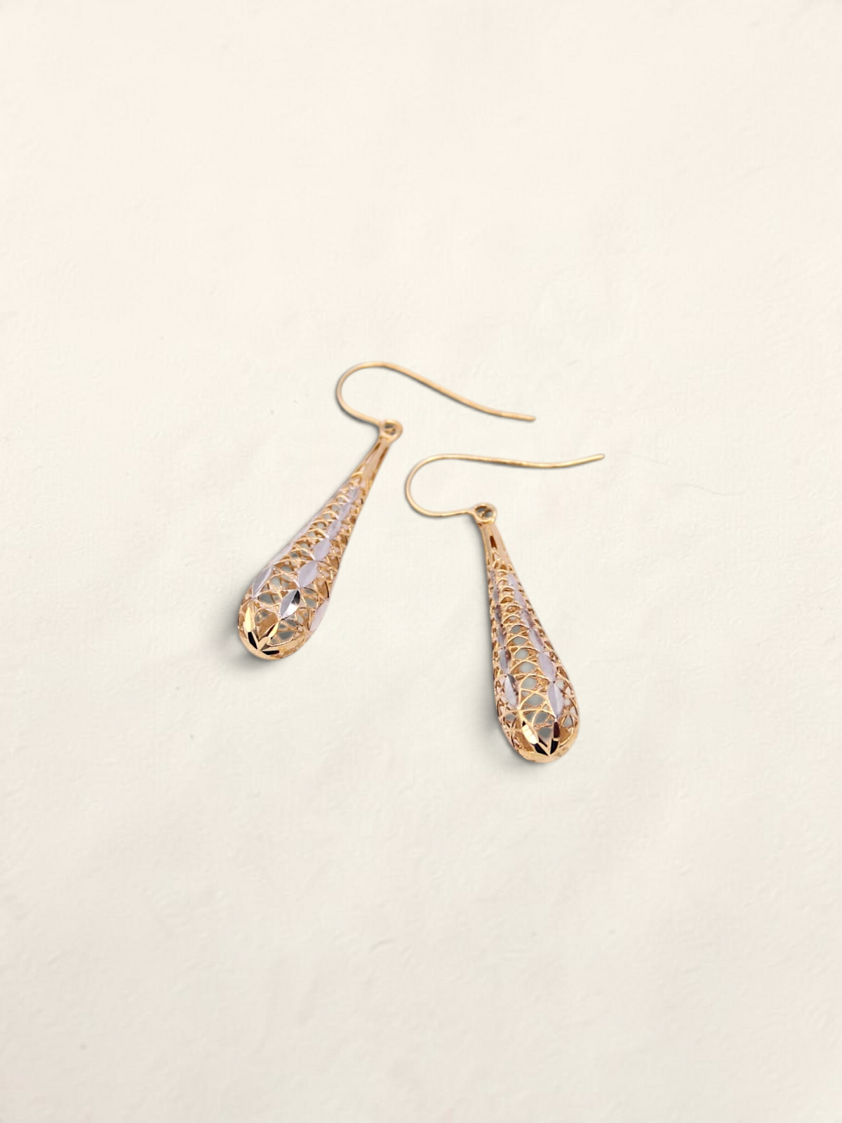 Zafrah 14K two-tone gold dropdown earrings featuring an intricate lattice design on a light background.