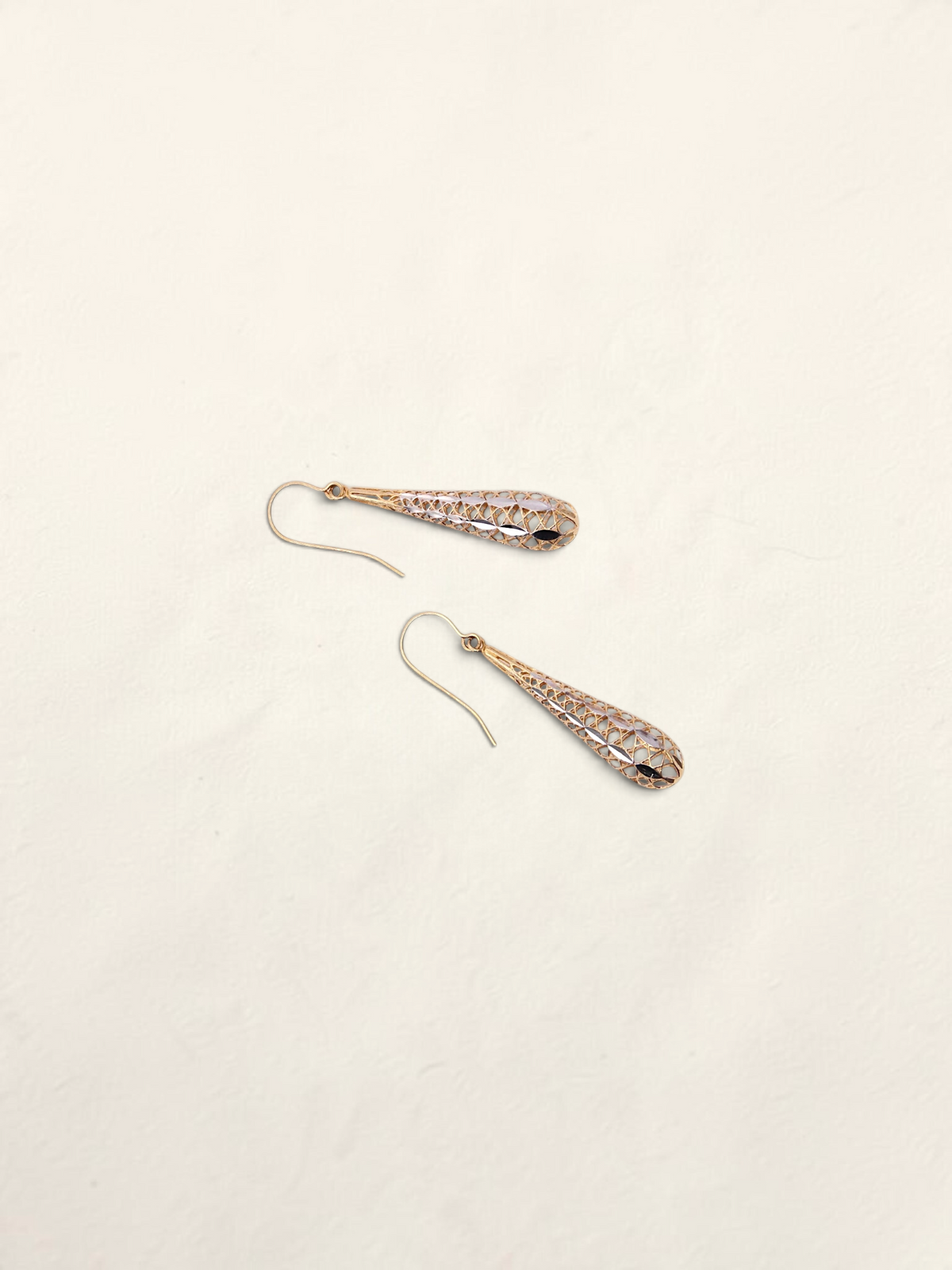Zafrah 14K two-tone gold dropdown earrings featuring an intricate lattice design on a light background