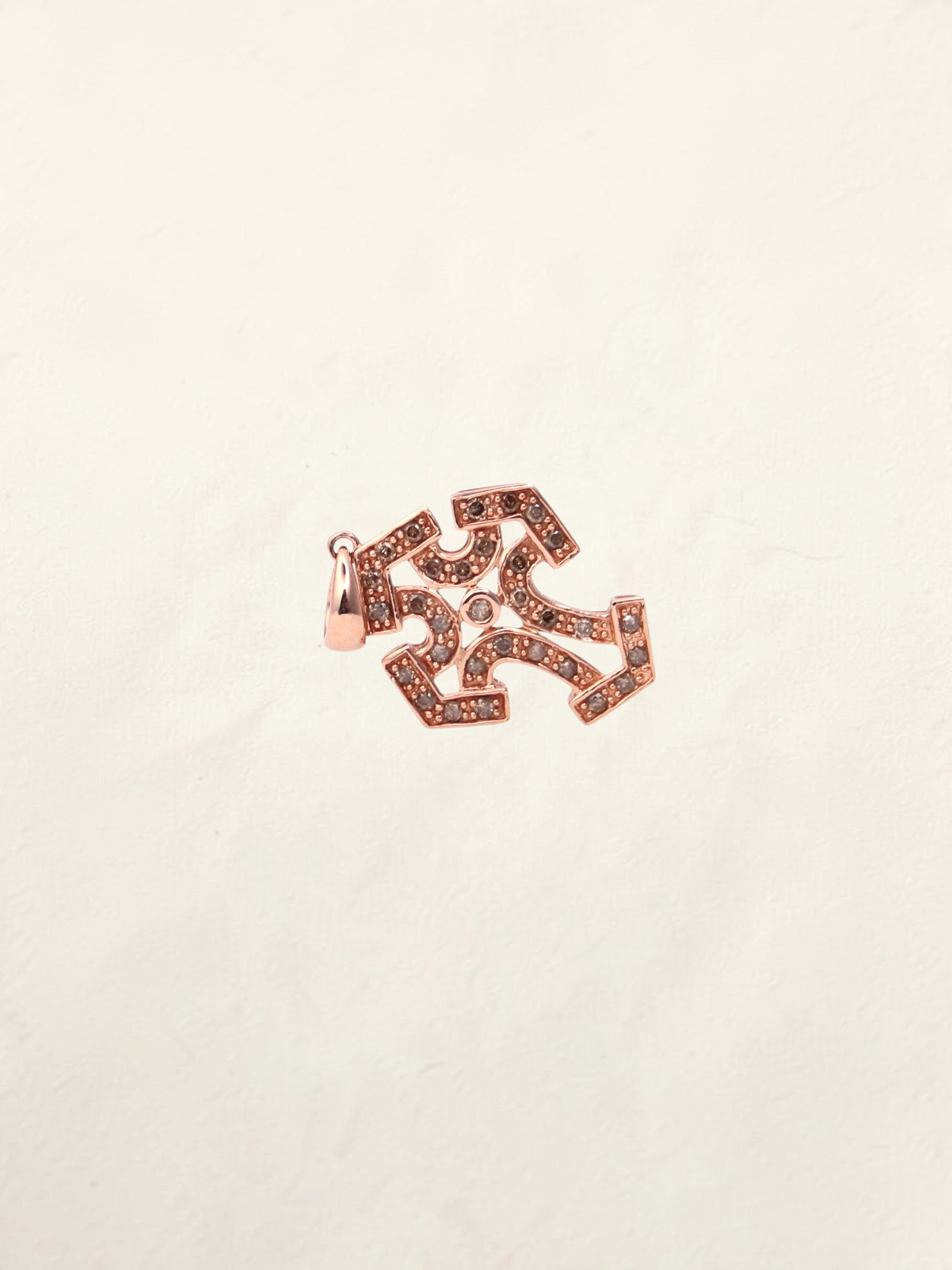 Zafrah 10k rose gold cross pendant featuring intricate filigree details and sparkling chocolate round diamonds.