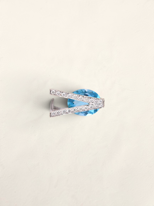 Zafrah 18K white gold abstract ring featuring an oval sky blue topaz accented by sparkling round diamonds.