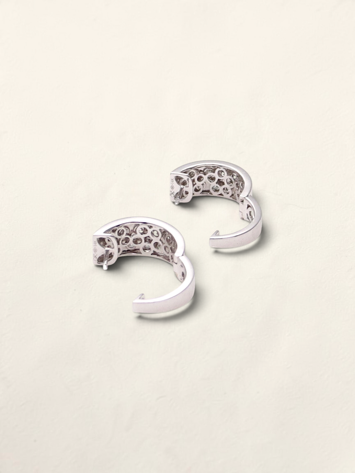 Zafrah 14k white gold huggie hoop earrings featuring a pavé setting of round black and white diamonds.