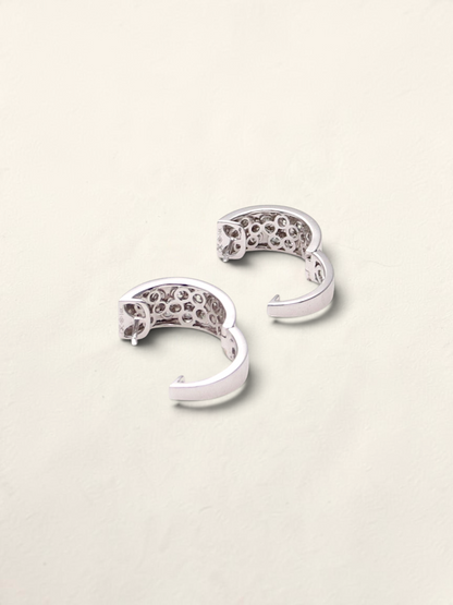 Zafrah 14k white gold huggie hoop earrings featuring a pavé setting of round black and white diamonds.