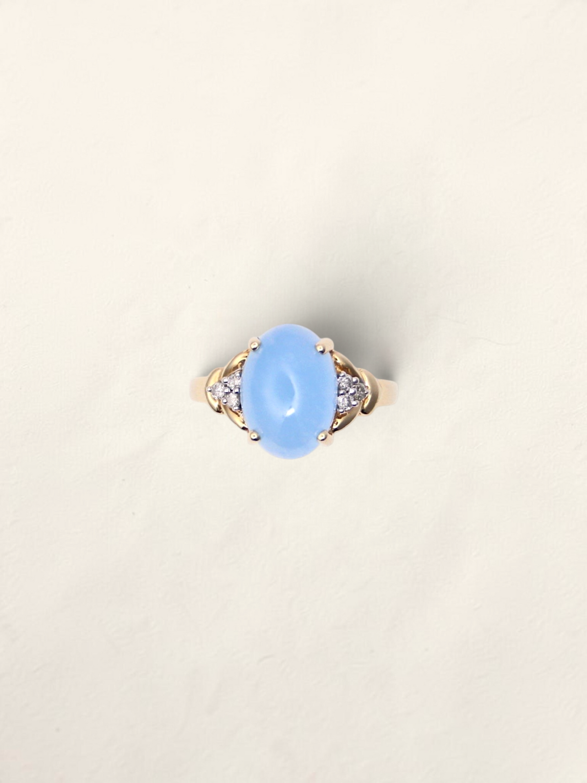 Zafrah 14K yellow gold ring featuring an oval blue jadeite stone accented by six round diamonds