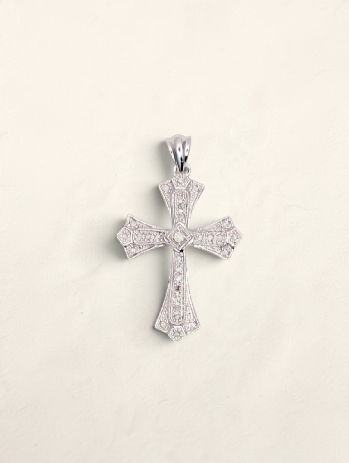 Zafrah 10k white gold cross pendant featuring 0.31ctw round diamonds in an ornate, detailed design.