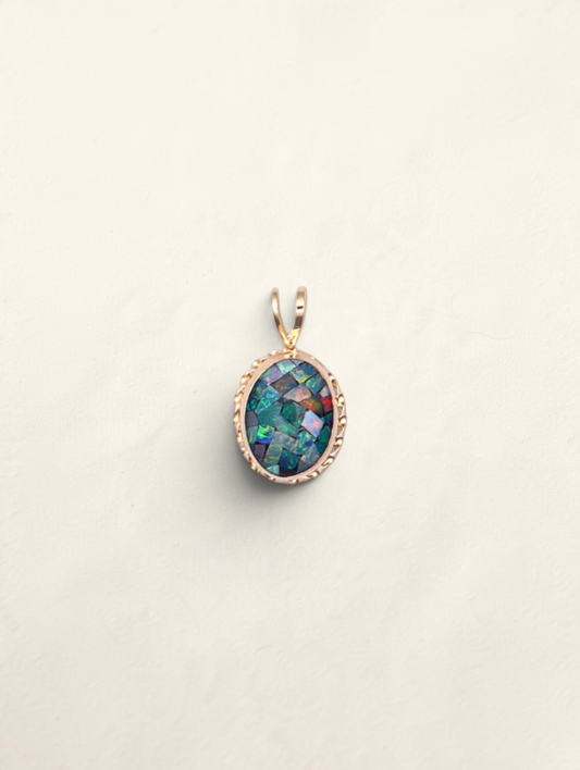 Zafrah 14k gold oval pendant featuring a mosaic-style blue epoxy inlay with iridescent accents on a light background.