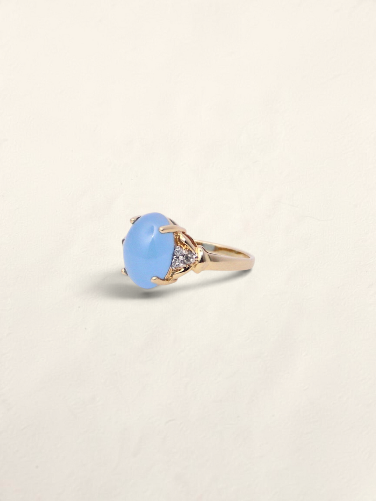 Zafrah 14K yellow gold ring featuring an oval blue jadeite cabochon accented with round diamonds.