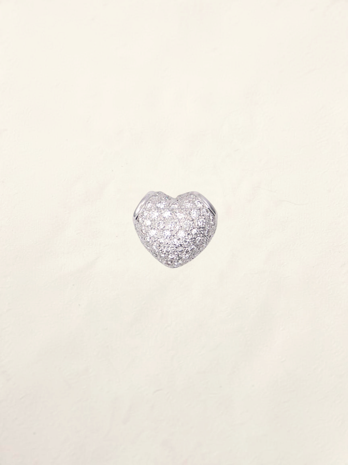 Zafrah 18K white gold heart pendant featuring a sparkling pavé diamond setting on a neutral background.