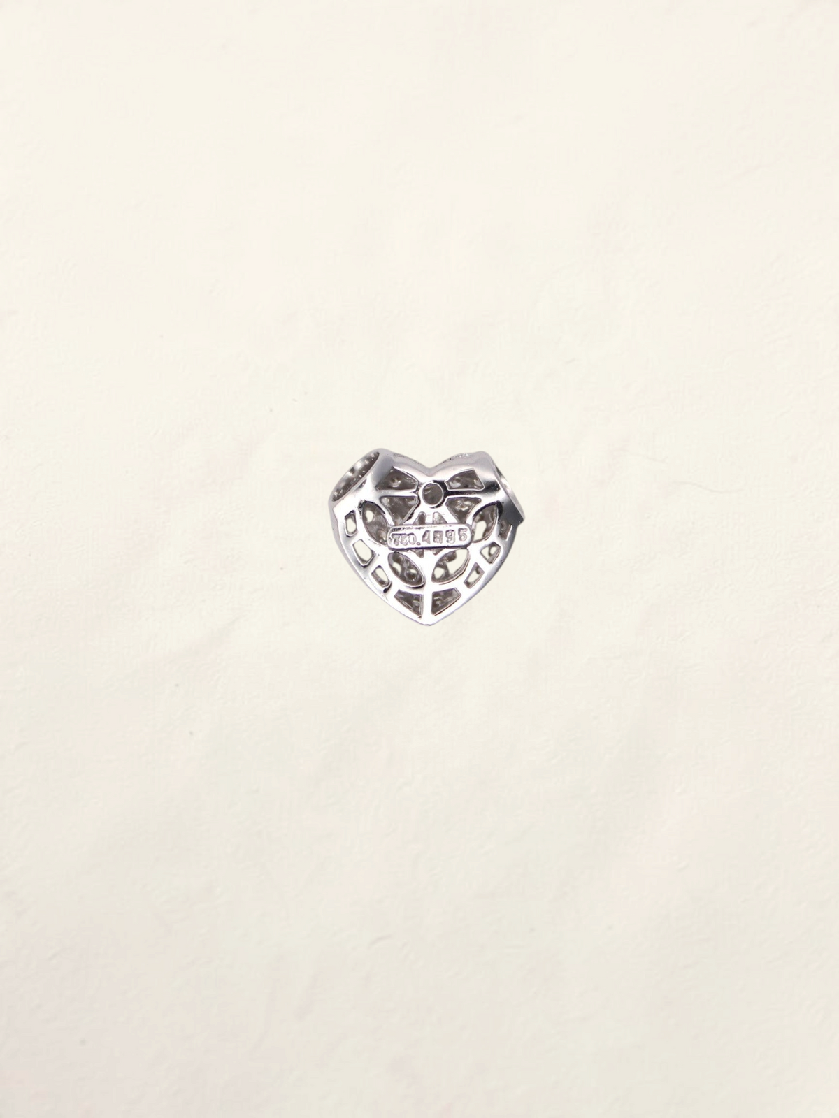 Zafrah 18K white gold heart pendant featuring a delicate pavé diamond setting on a light textured background