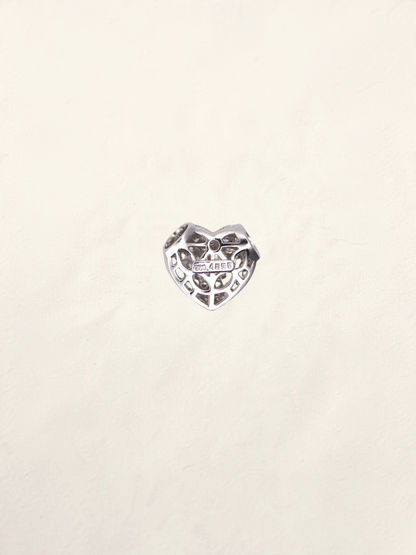 Zafrah 18K white gold heart pendant featuring a delicate pavé diamond setting on a light textured background