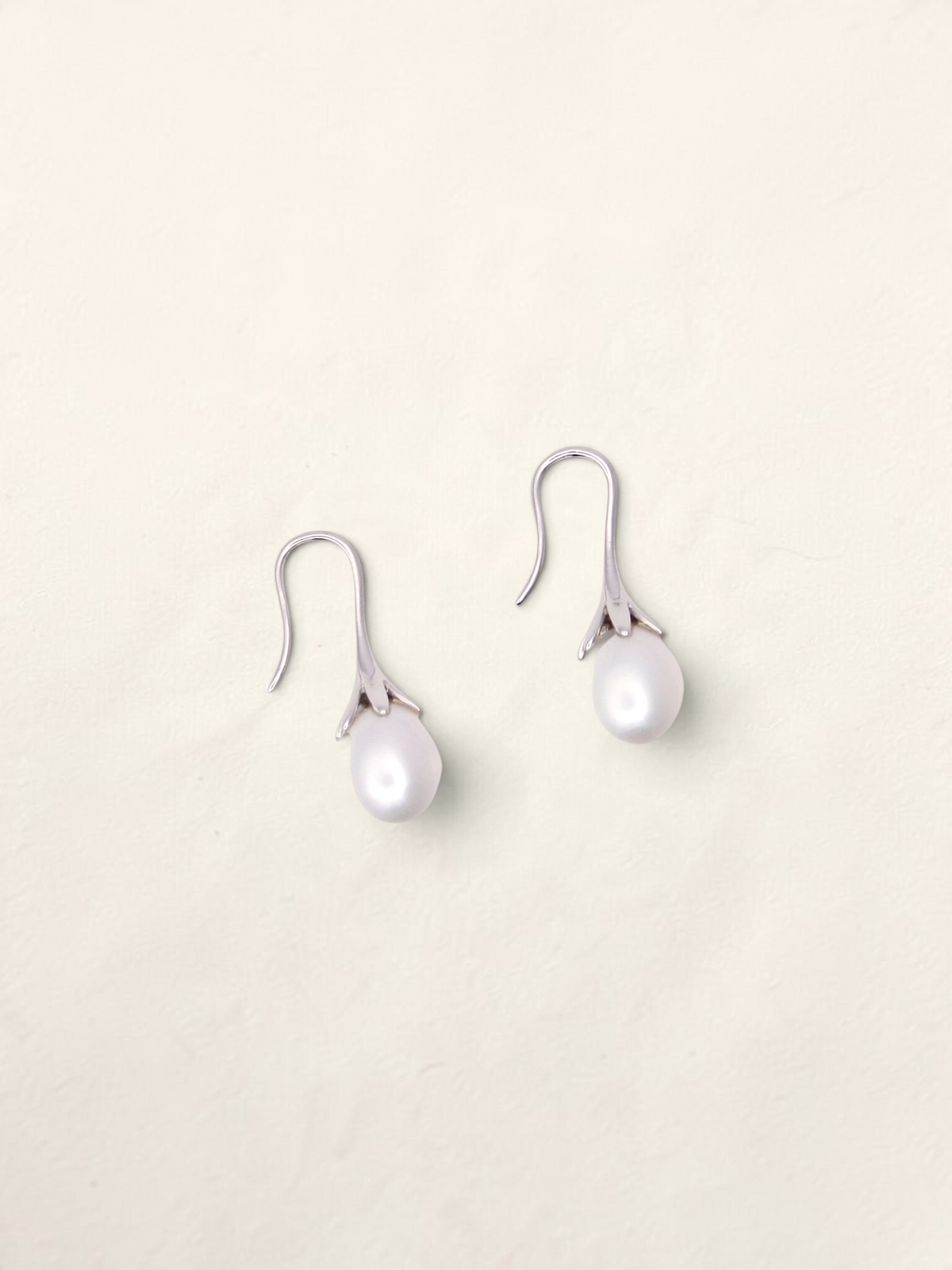 Zafrah 14K white gold drop earrings featuring elegant cultured pearls in a delicate floral-inspired setting.
