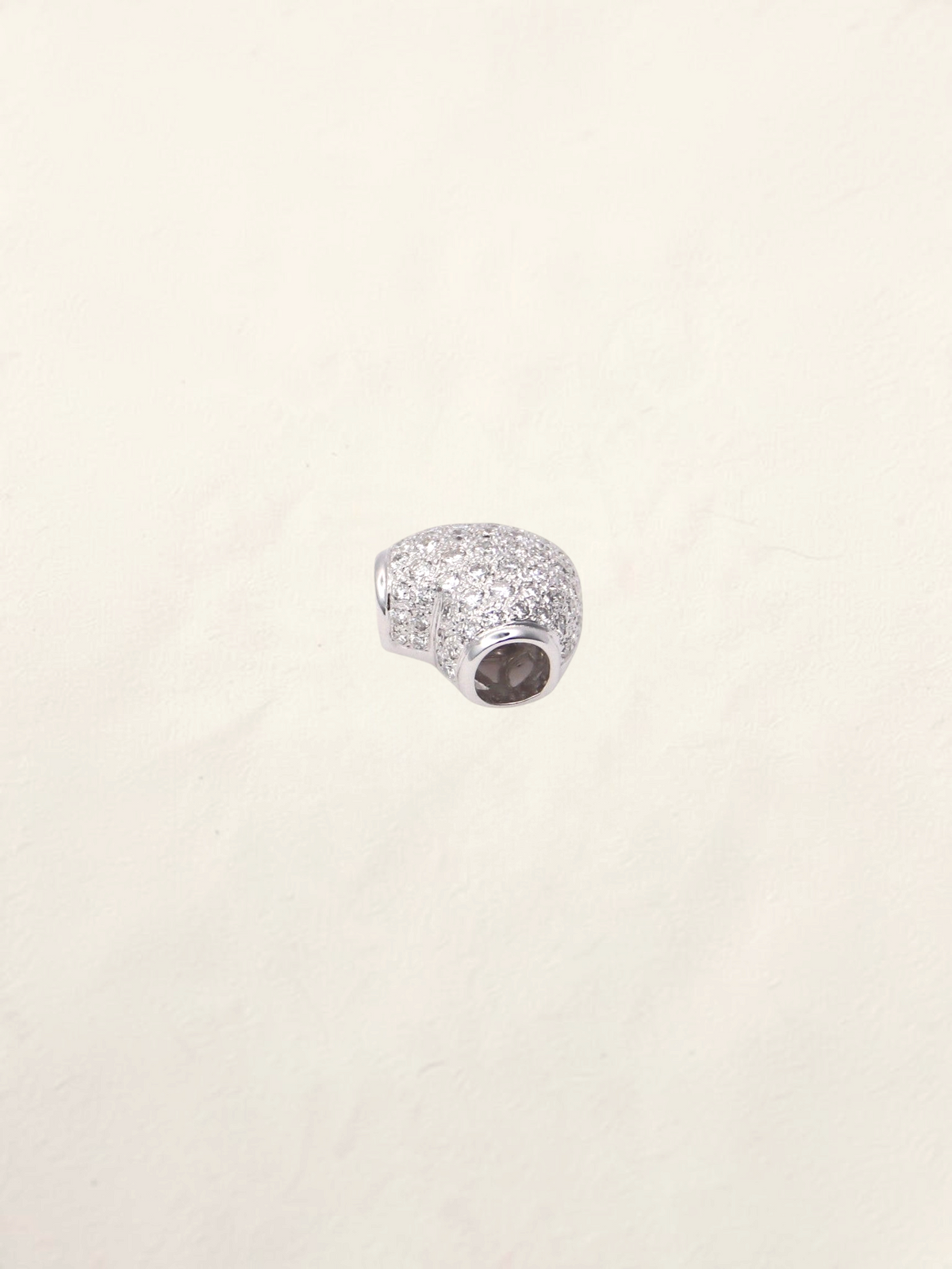 Zafrah 18k white gold heart pendant featuring pavé-set round diamonds on a polished metal surface.