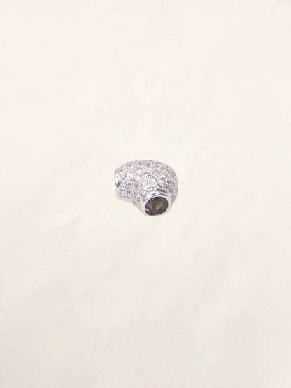 Zafrah 18k white gold heart pendant featuring pavé-set round diamonds on a polished metal surface.