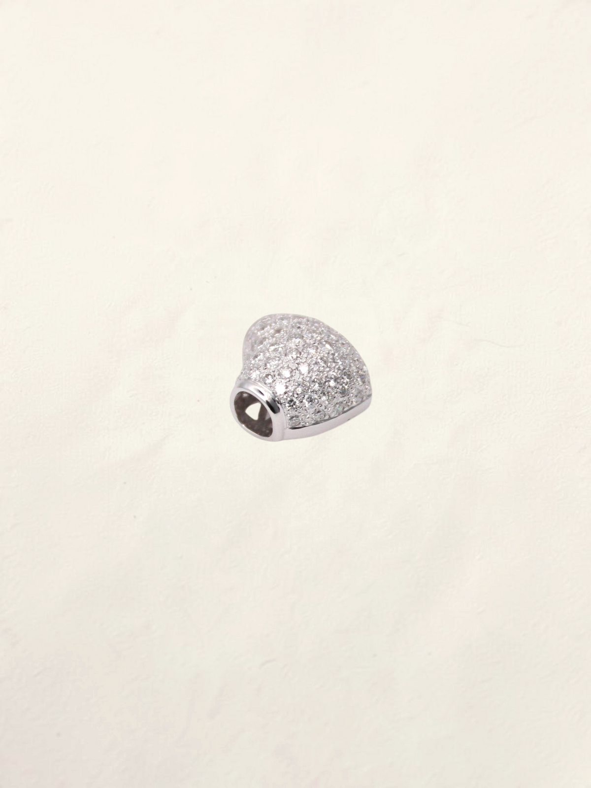 Zafrah 18K white gold heart pendant featuring a sparkling pavé diamond setting on a neutral background.