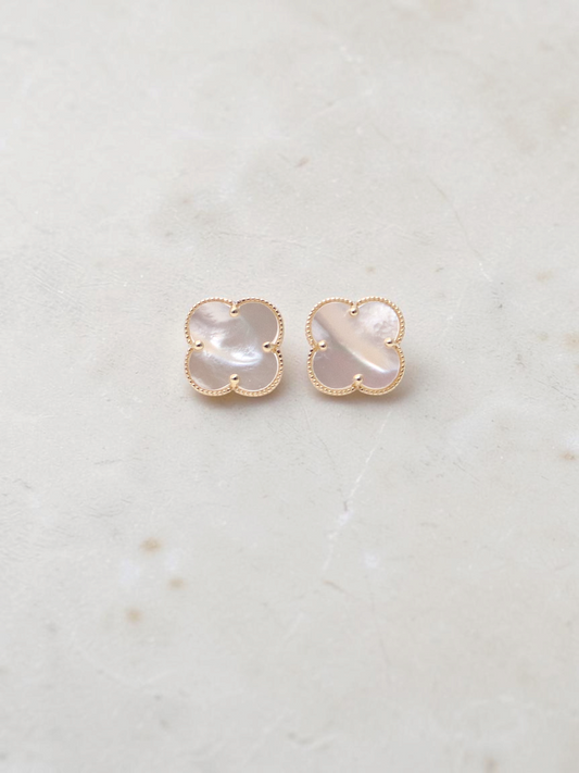 Zafrah 14k yellow gold stud earrings featuring iridescent mother of pearl clover motifs on a white background