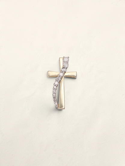Zafrah 10k yellow gold cross pendant featuring a curved row of graduated round diamonds on a polished gold base.