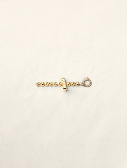 Zafrah 10K yellow gold cross pendant featuring a textured moon cut bead design on a white background