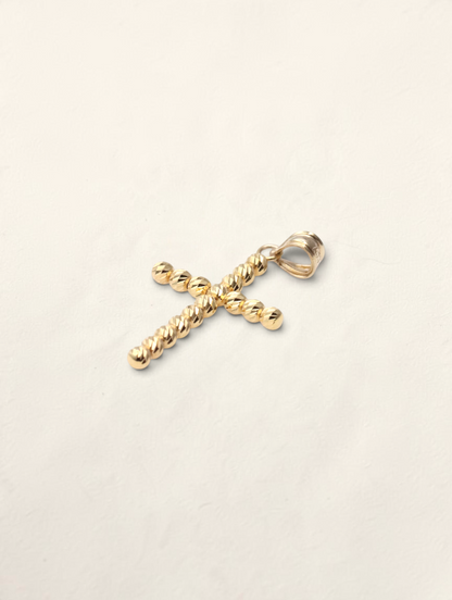 Zafrah 10K yellow gold cross pendant featuring a textured moon cut design on a simple white background.