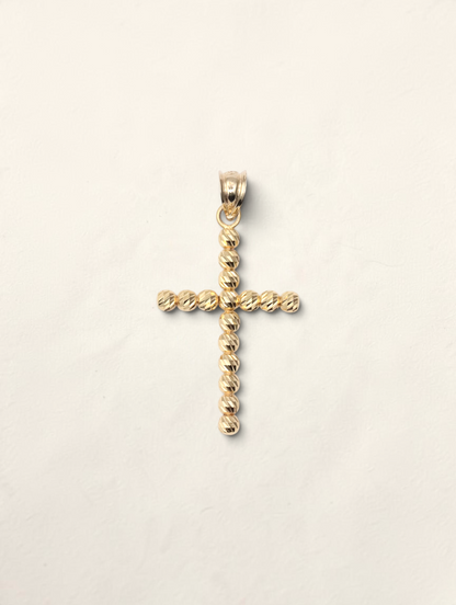 Zafrah 10k yellow gold cross pendant featuring a textured moon cut bead design on a white background