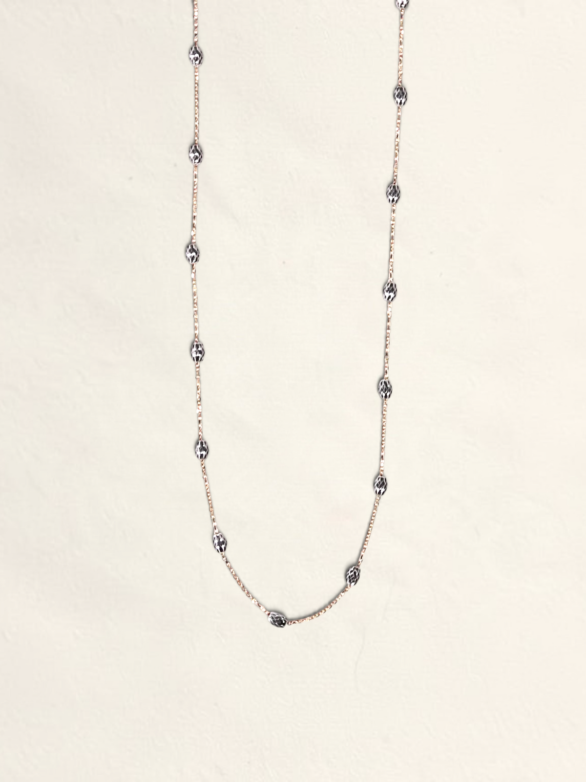 Zafrah 16-inch 14K two-tone gold necklace featuring textured Saturn beads on a delicate chain