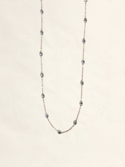 Zafrah 16-inch 14K two-tone gold necklace featuring textured Saturn beads on a delicate chain