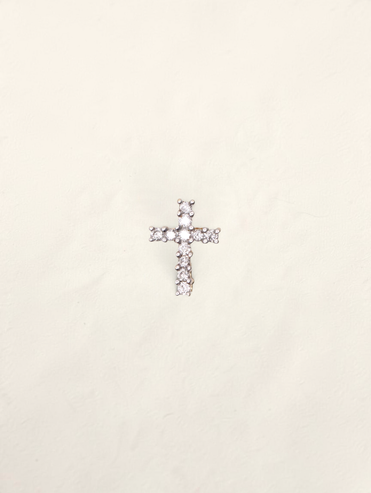 Zafrah 14k yellow gold mini cross pendant featuring 11 round brilliant cut diamonds set in a delicate design.