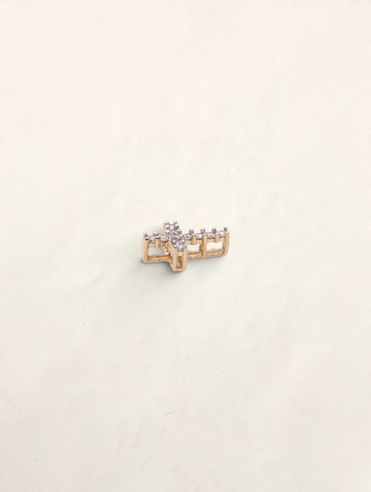 Zafrah 14k yellow gold mini cross pendant featuring 11 round diamonds in a delicate, polished setting.