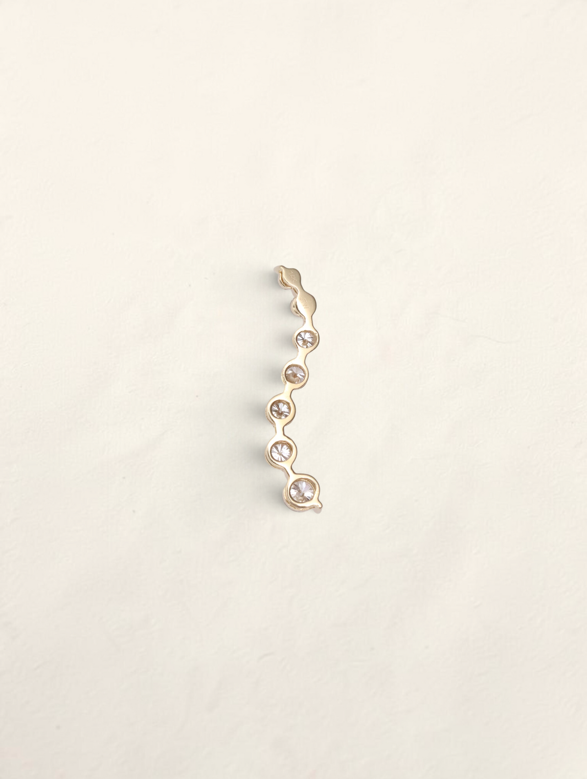 Zafrah 14k yellow gold curved journey pendant featuring seven graduated round diamonds in a vertical wave design