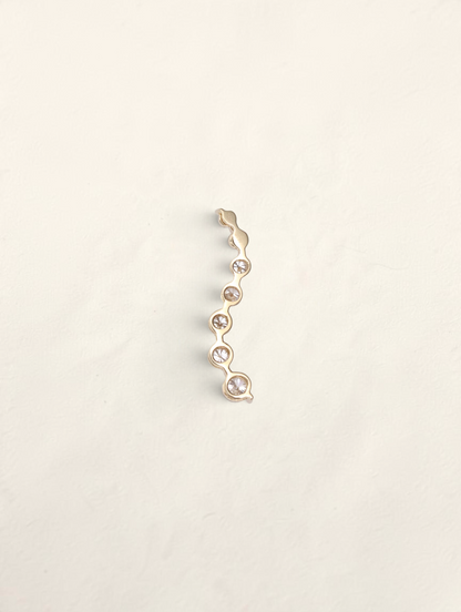 Zafrah 14k yellow gold curved journey pendant featuring seven graduated round diamonds in a vertical wave design