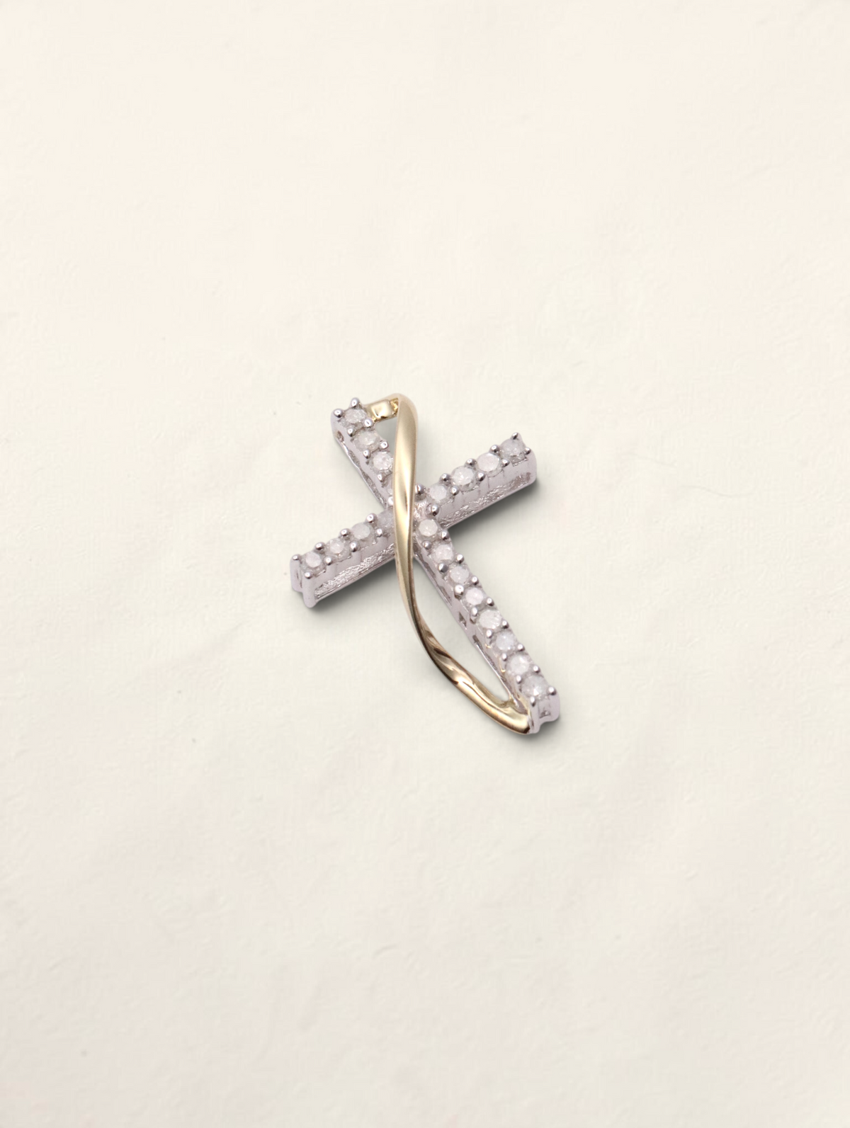 Zafrah 10K two-tone gold small cross pendant featuring 0.2ctw round diamond accents in a delicate twisted design.