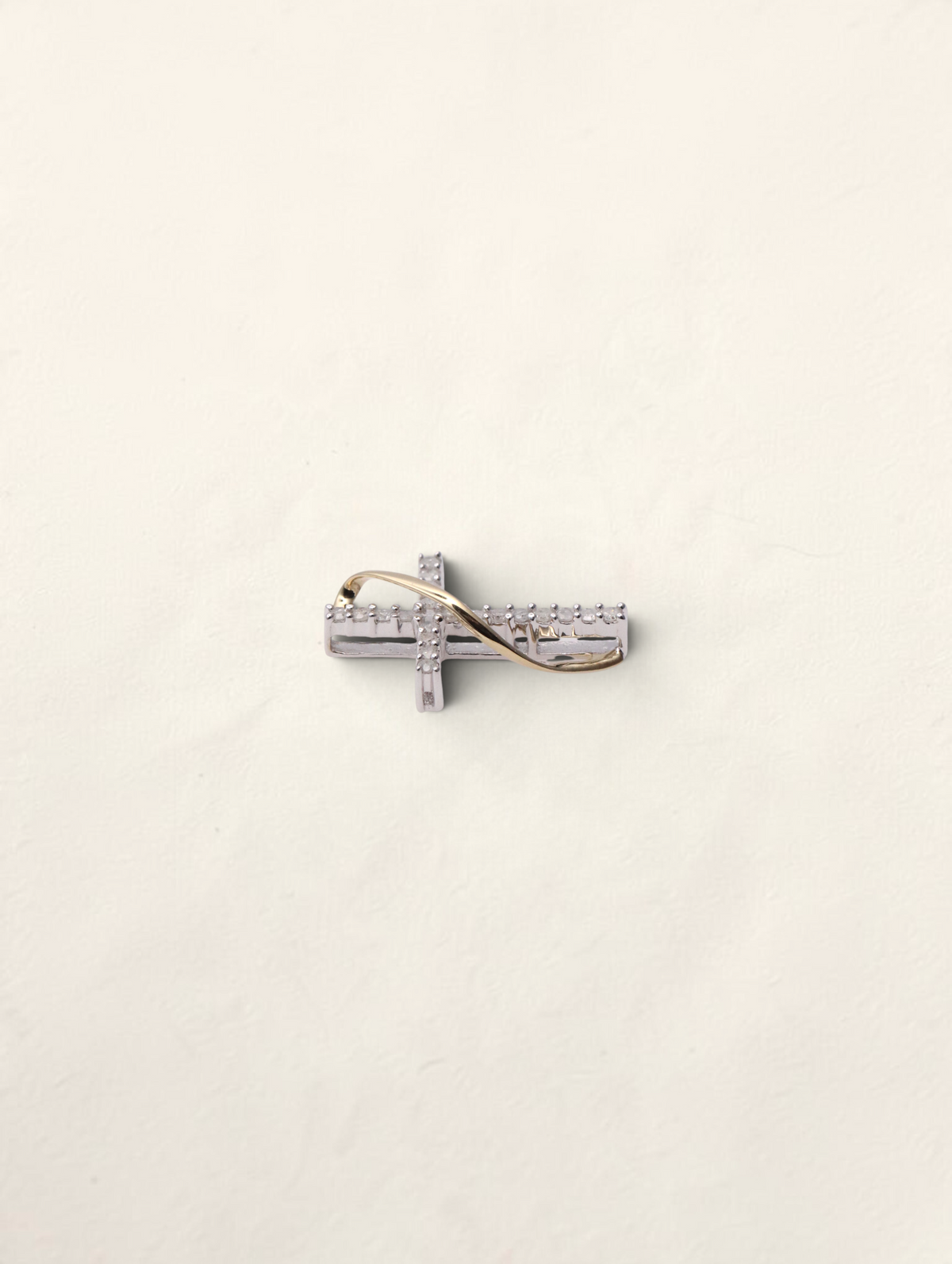 Zafrah 10K two-tone gold small cross pendant featuring 0.2ctw round diamonds in a delicate twisted design