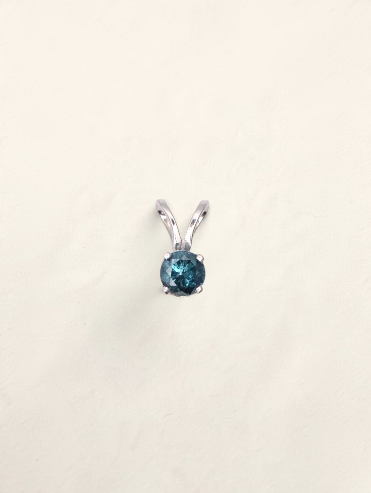 Zafrah 14k white gold solitaire pendant featuring a round 0.21ct blue diamond on a simple prong setting