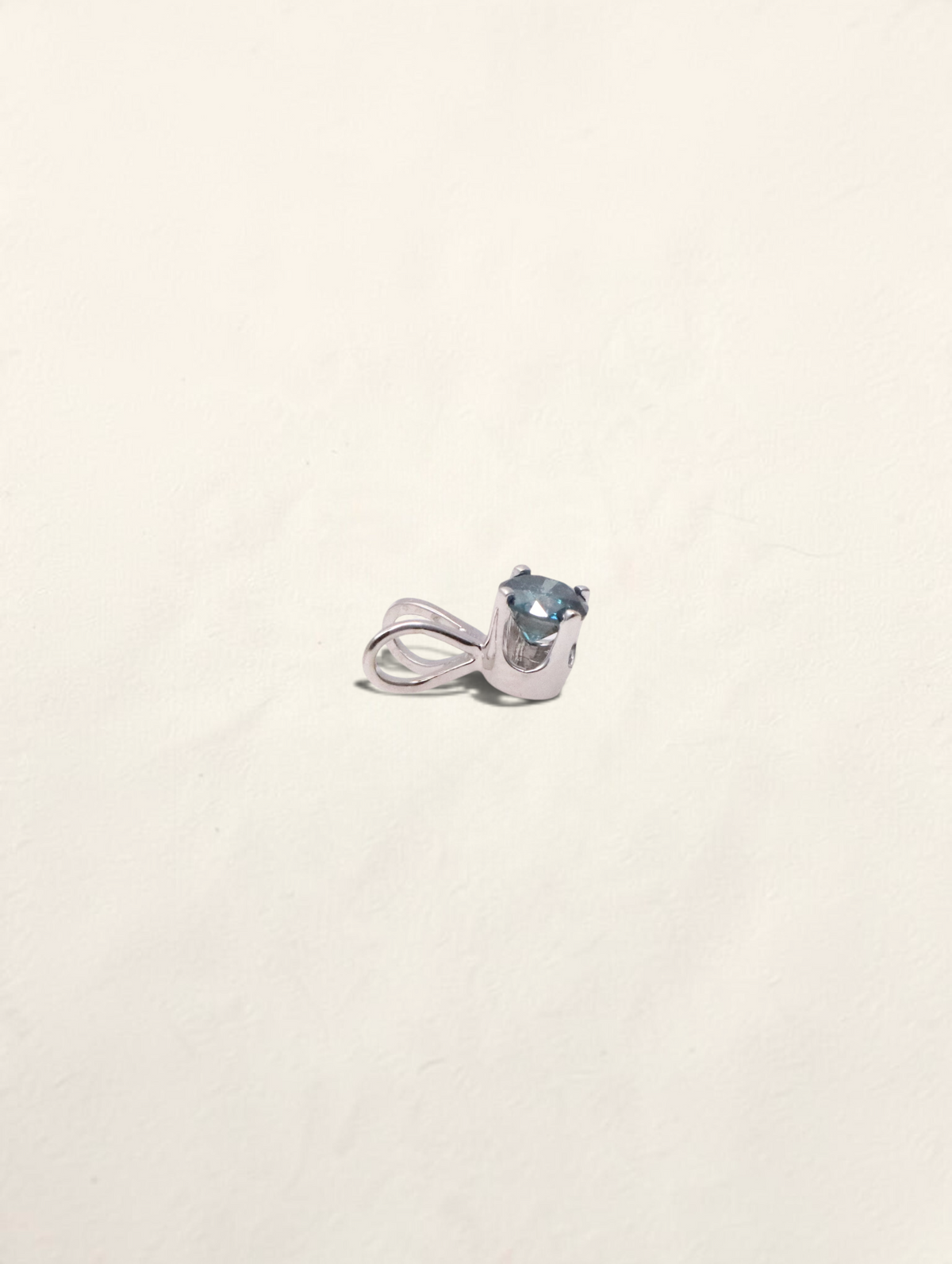 Zafrah 14k white gold solitaire pendant featuring a round blue diamond in a classic prong setting